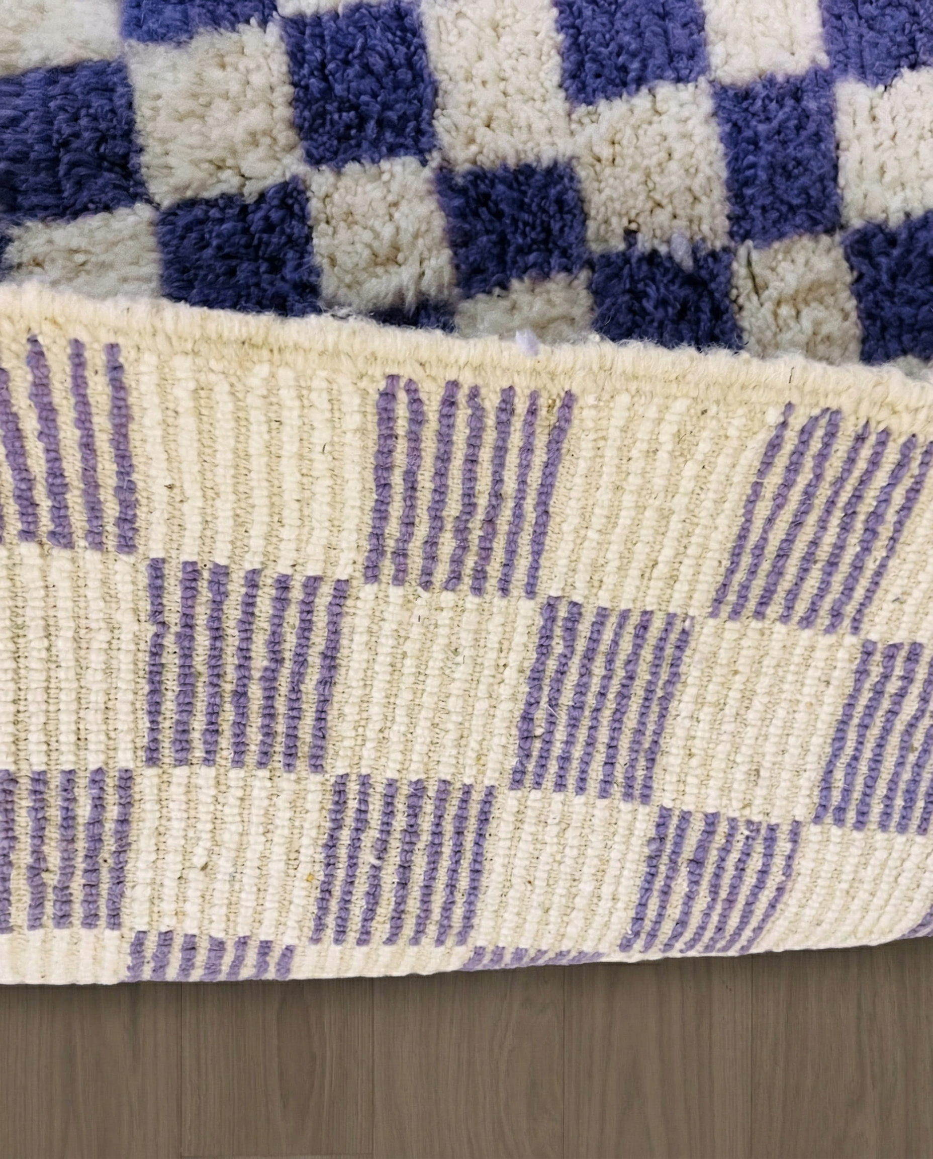 MOUNA Beni Ourain violet checker grid Moroccan rug close-up showing hand-knotted wool texture and pile detail 2, by NURA