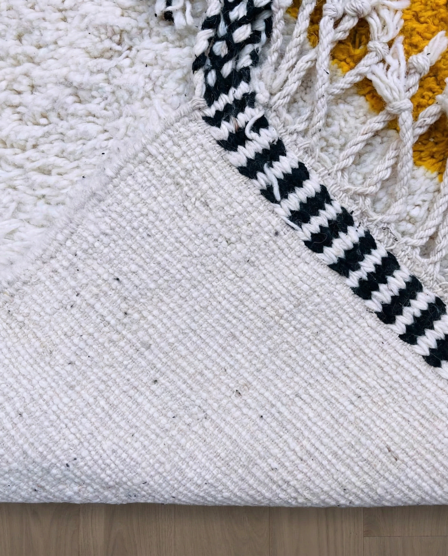 MOUNIA Beni Ourain ivory abstract color block Moroccan rug back view showing traditional handwoven construction, by NURA