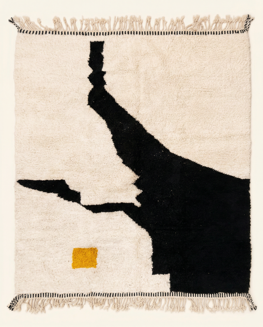 Plush ivory Beni Ourain Moroccan rug with a bold black abstract shape, mustard yellow square, and high pile, by NURA.