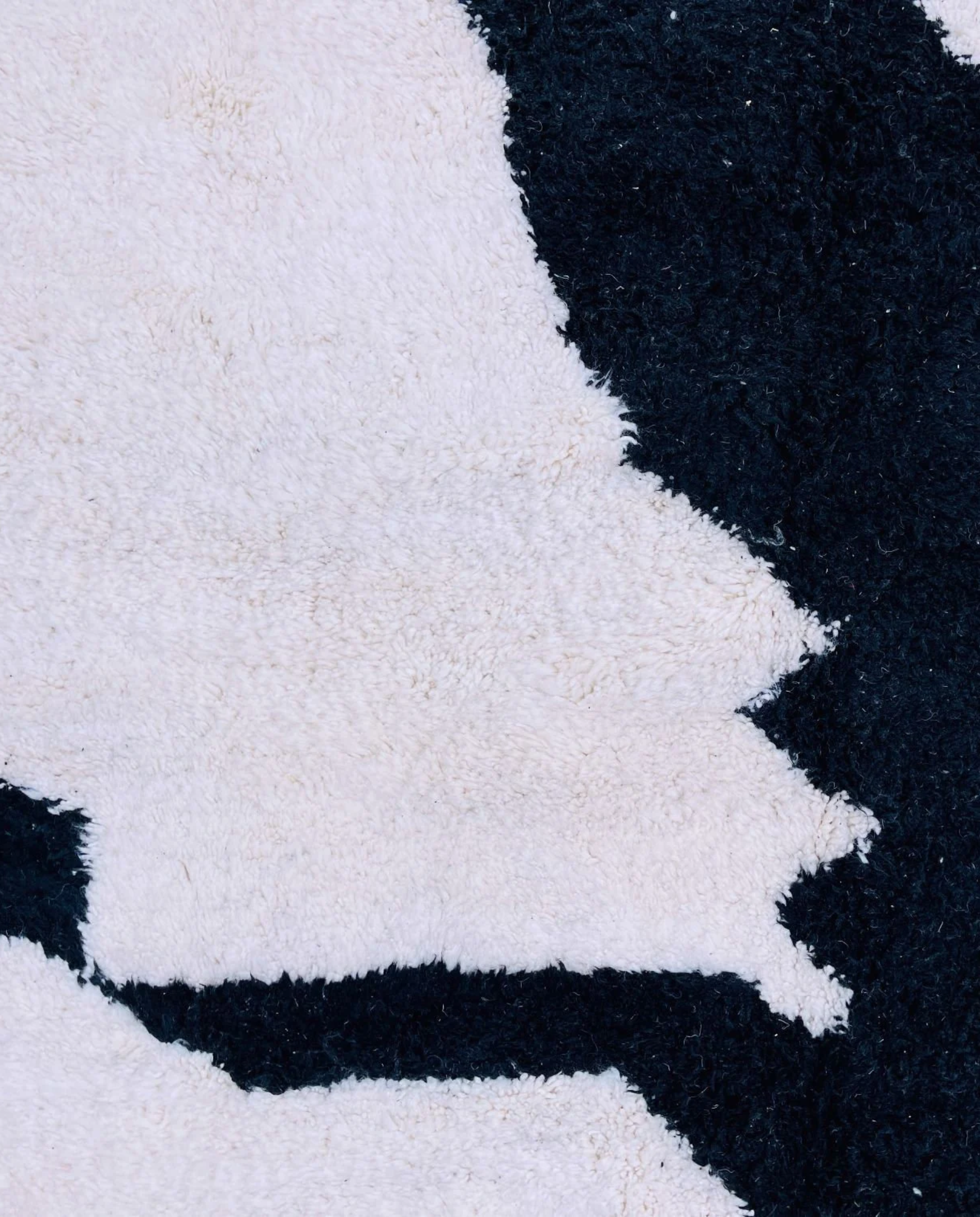 MOUNIA Beni Ourain ivory abstract color block Moroccan rug close-up showing hand-knotted wool texture and pile detail 1, by NURA