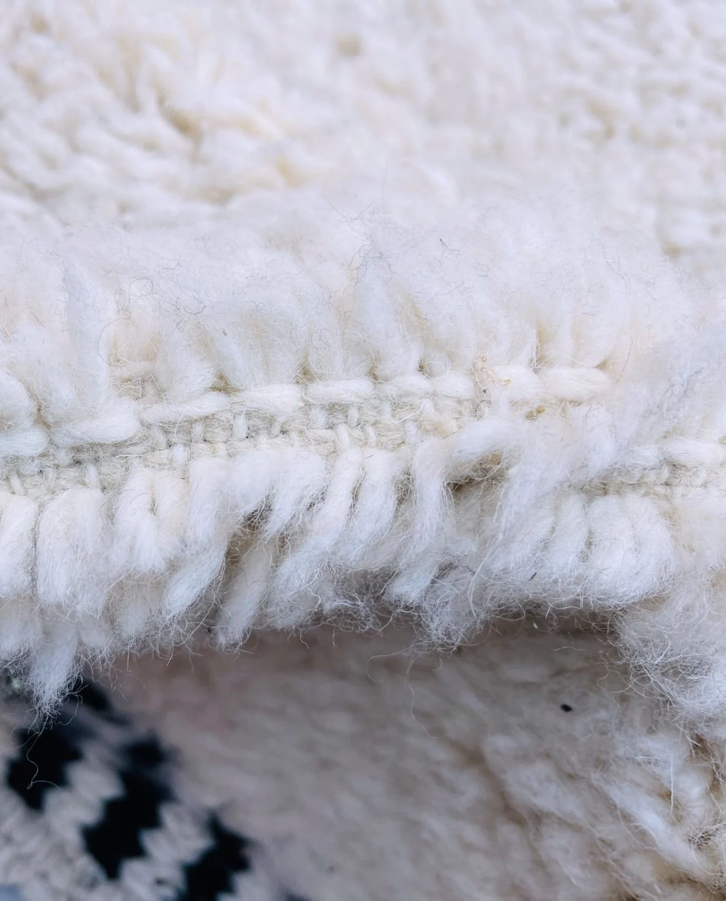 MOUNIA Beni Ourain ivory abstract color block Moroccan rug close-up showing hand-knotted wool texture and pile detail 2, by NURA