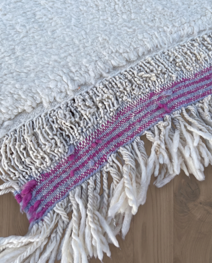 MOUNIRA Azilal ivory abstract color block Moroccan rug close-up of hand-tied fringe and kilim band detail, by NURA