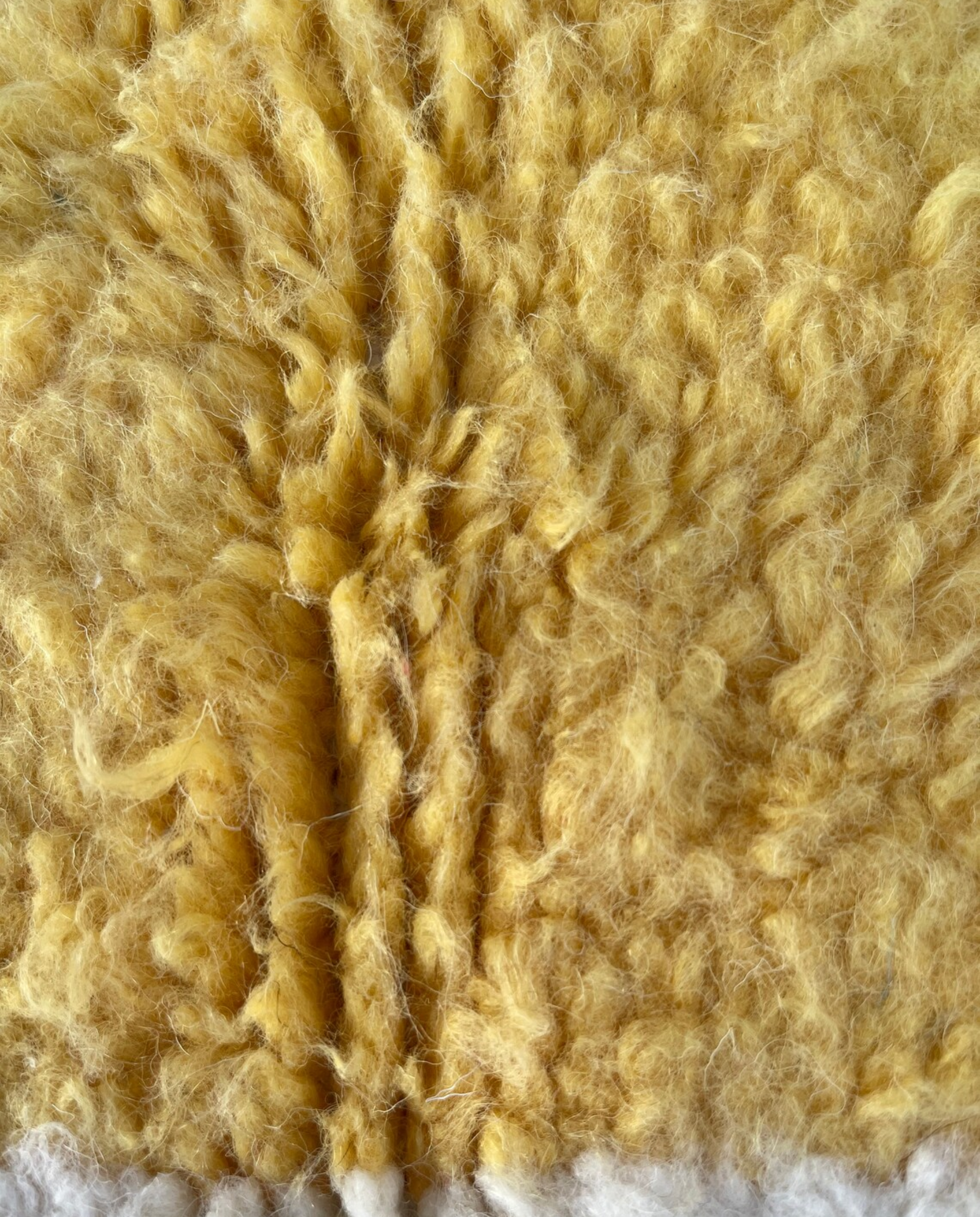 MOUNIRA Azilal ivory abstract color block Moroccan rug close-up showing hand-knotted wool texture and pile detail, by NURA