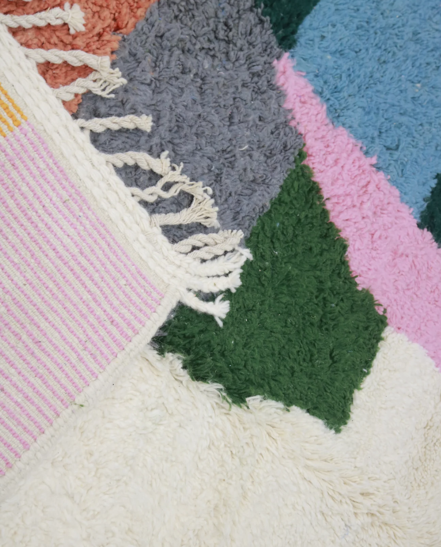 MUNIKA Azilal cream color block Moroccan rug close-up of hand-tied fringe and kilim band detail, by NURA