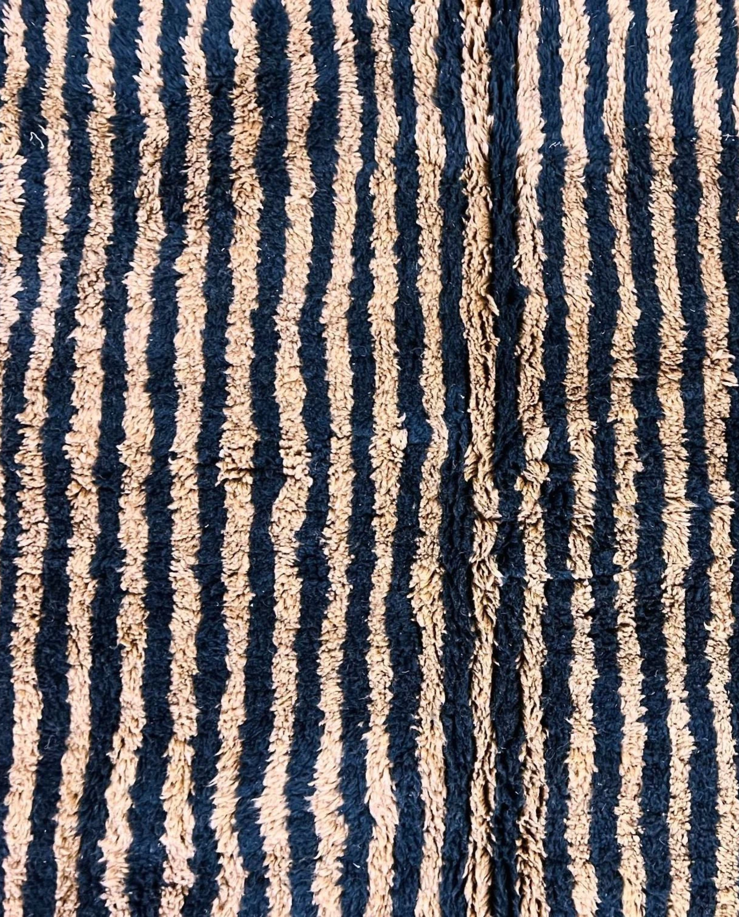 NABILA Beni Ourain black horizontal stripes Moroccan rug close-up showing hand-knotted wool texture and pile detail 1, by NURA