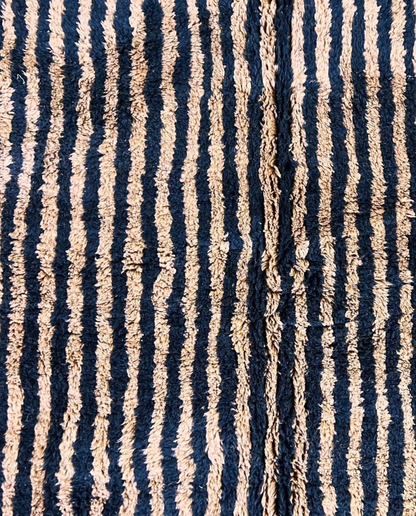 NABILA Beni Ourain black horizontal stripes Moroccan rug close-up showing hand-knotted wool texture and pile detail 1, by NURA