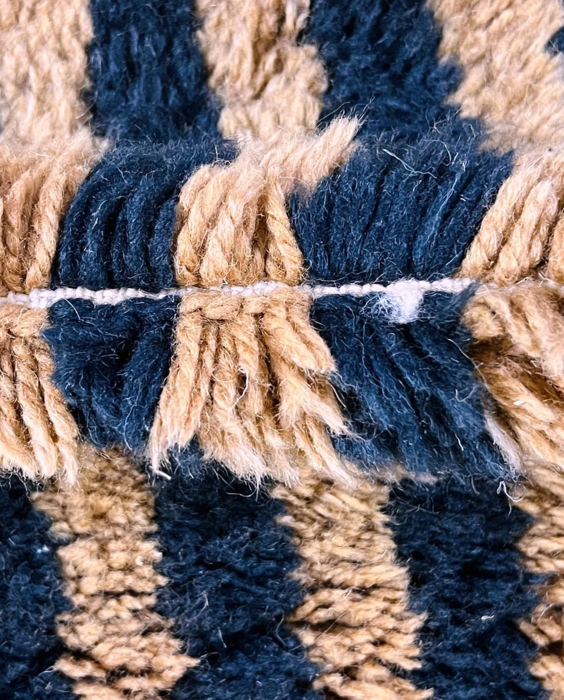 NABILA Beni Ourain black horizontal stripes Moroccan rug close-up showing hand-knotted wool texture and pile detail 2, by NURA