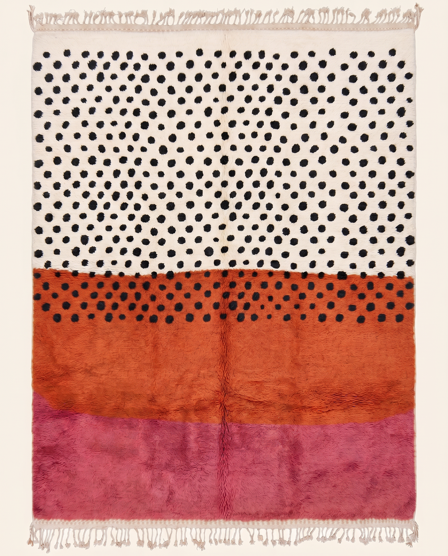 Bold color-blocked Azilal Moroccan rug by NURA featuring plush cream, terracotta, and pink bands with scattered black dots.