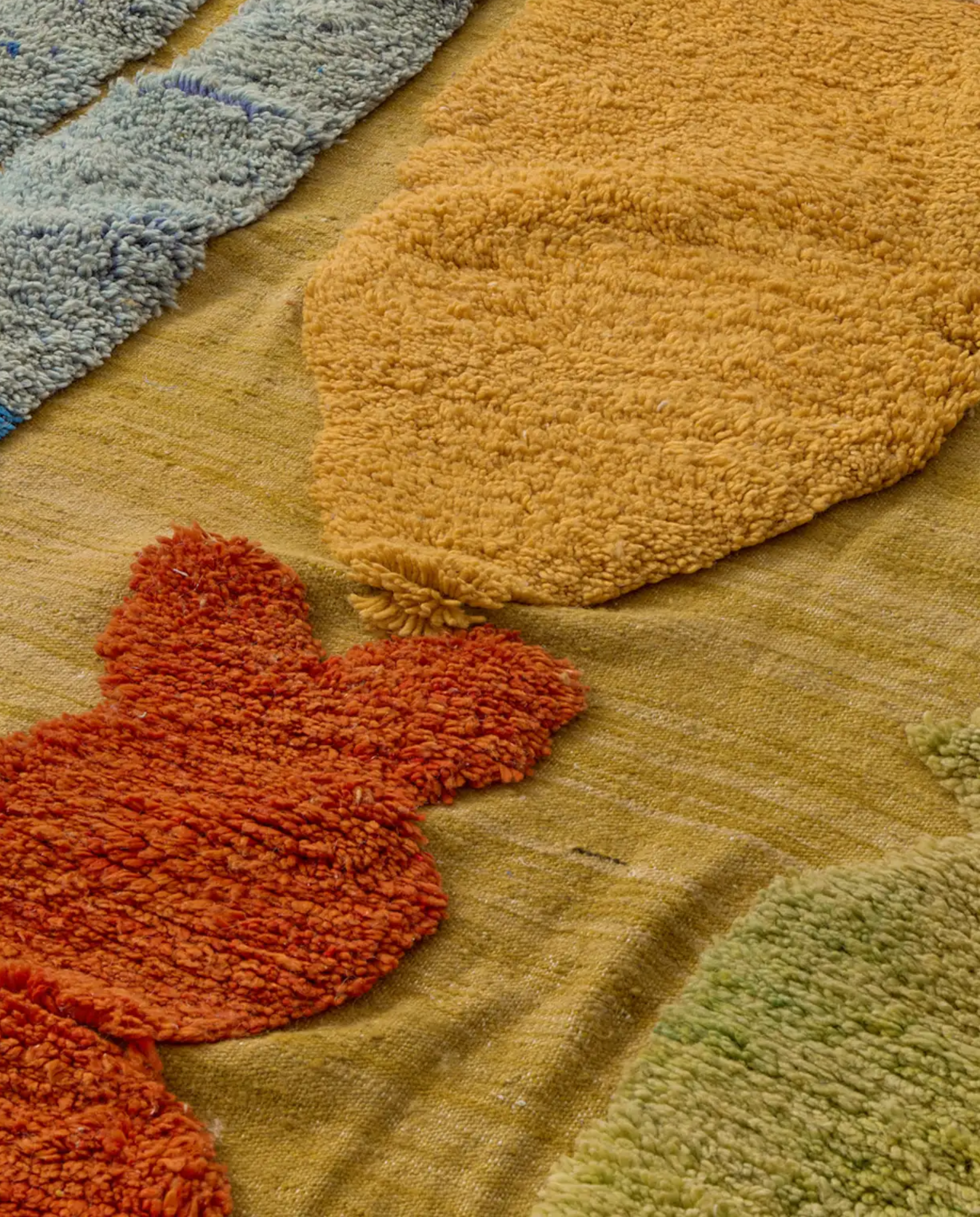 NAIMA Azilal mustard organic abstract field Moroccan rug close-up showing hand-knotted wool texture and pile detail, by NURA