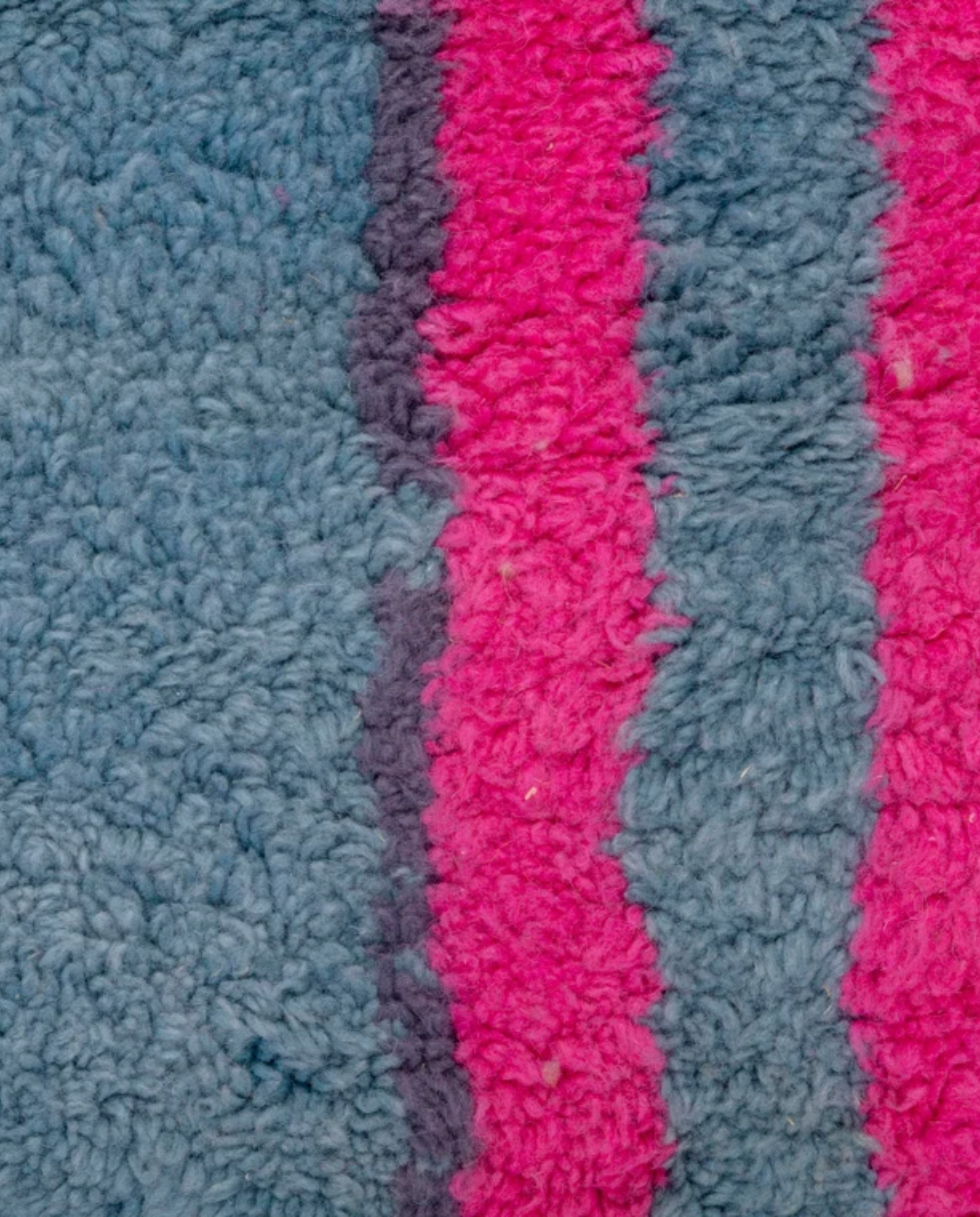NAJIA Azilal slate blue painterly abstract field Moroccan rug close-up showing hand-knotted wool texture and pile detail, by NURA