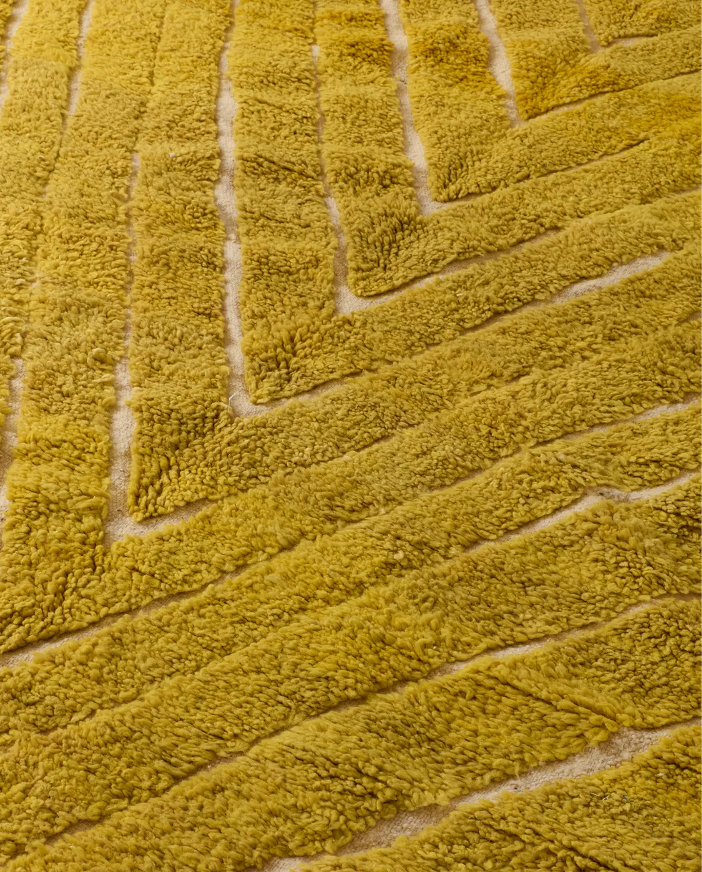 NAJWA Azilal mustard textured chevron Moroccan rug close-up showing hand-knotted wool texture and pile detail, by NURA