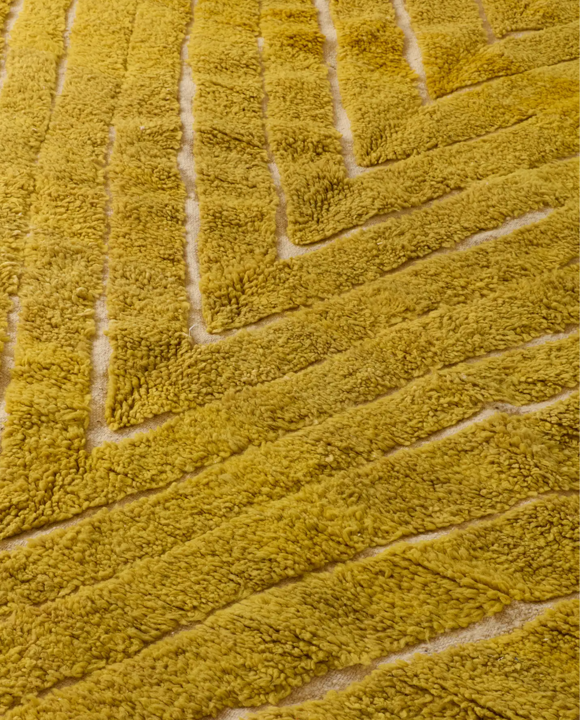 NAJWA Azilal mustard textured chevron Moroccan rug close-up showing hand-knotted wool texture and pile detail, by NURA