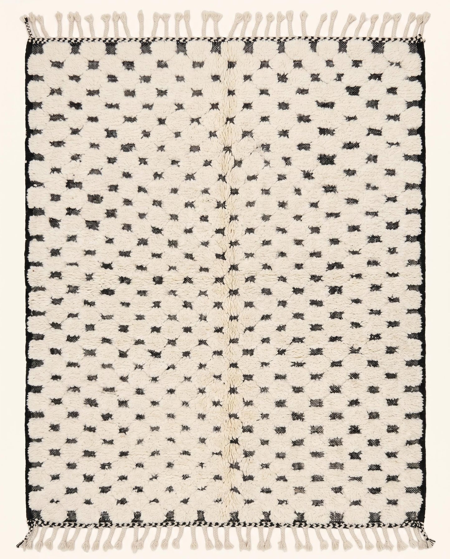 Plush cream Moroccan rug featuring a minimalist black dotted checker grid pattern, hand-knotted in wool by NURA.