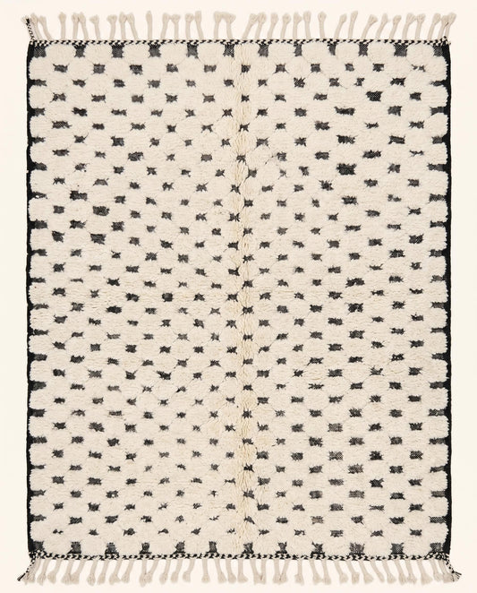 Plush cream Moroccan rug featuring a minimalist black dotted checker grid pattern, hand-knotted in wool by NURA.