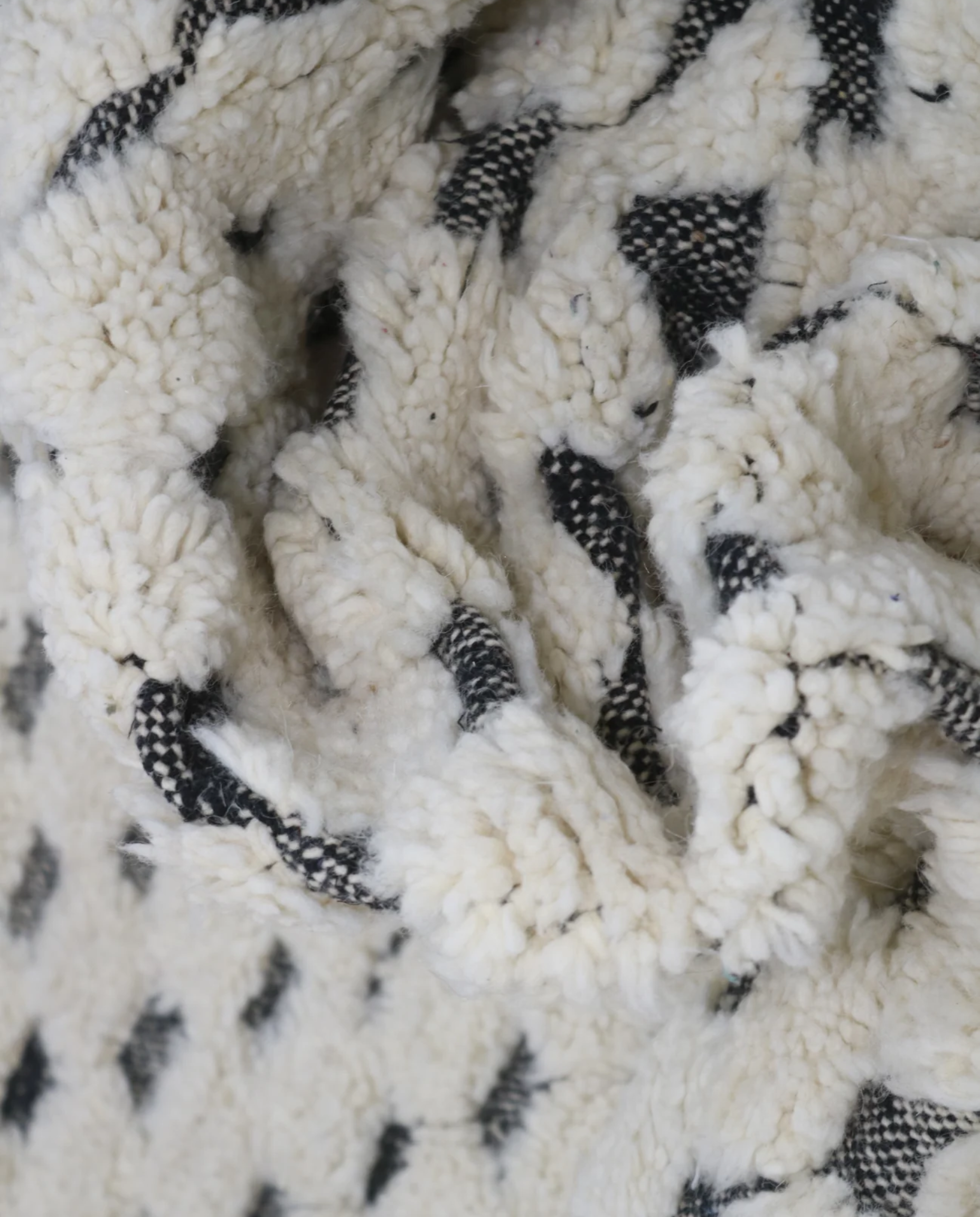 NANNA Beni Ourain cream checker grid Moroccan rug close-up showing hand-knotted wool texture and pile detail, by NURA