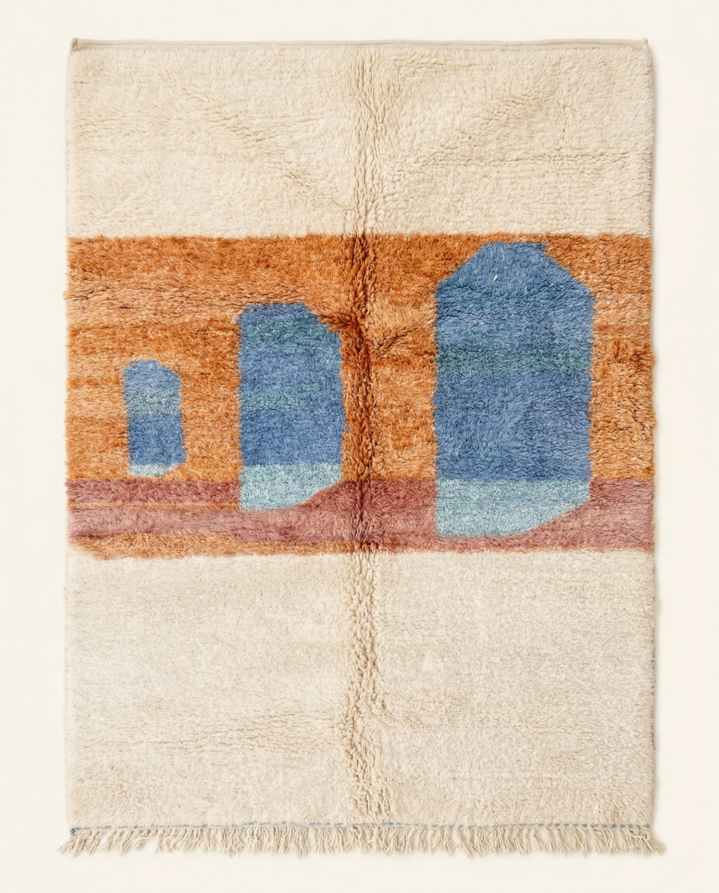 Plush cream Beni Ourain Moroccan rug with a bold abstract color block design featuring blue arches on a terracotta ground, by NURA.