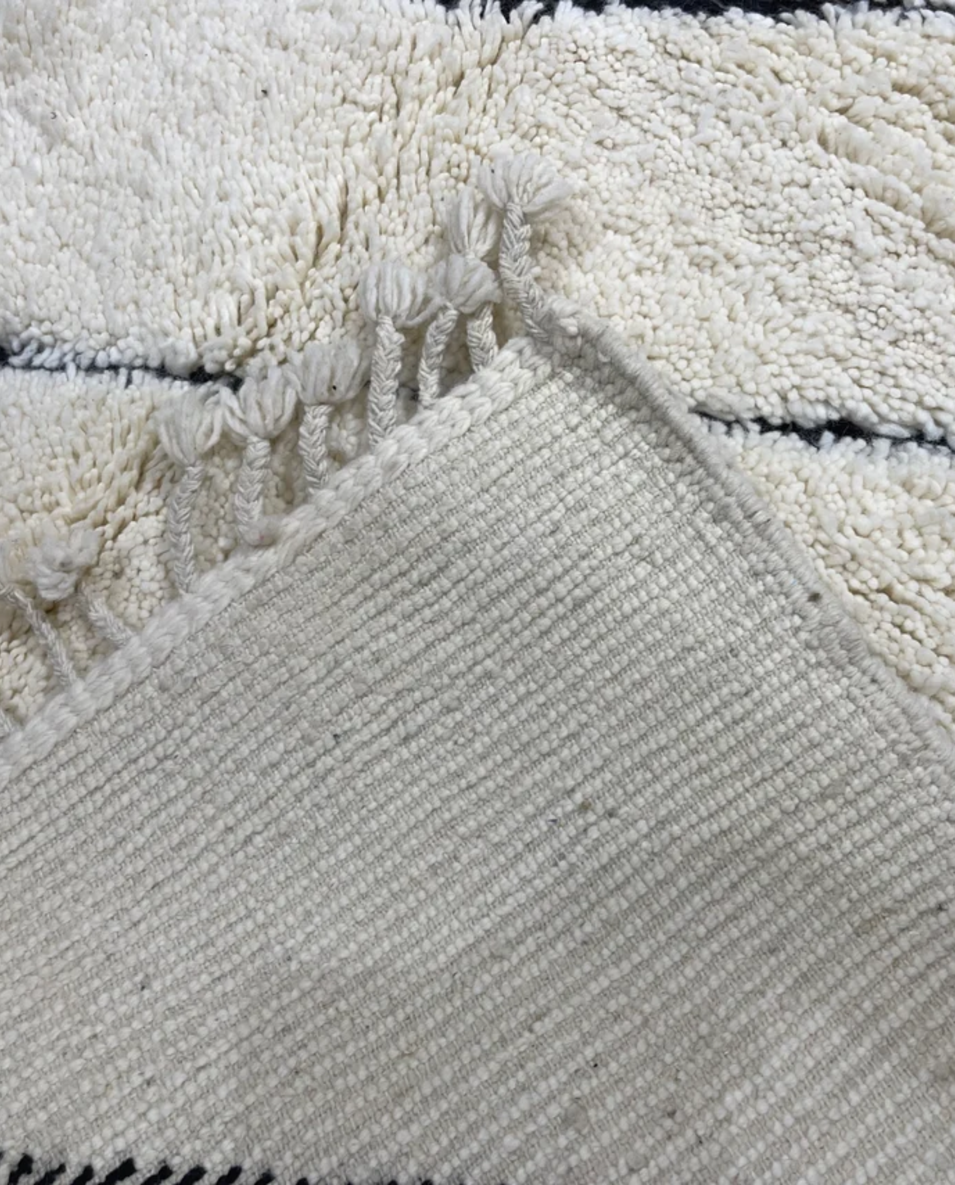 NASSIMA Beni Ourain ivory abstract diamond lattice Moroccan rug back view showing traditional handwoven construction, by NURA