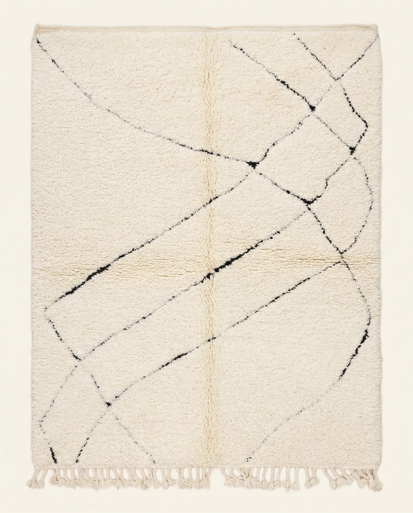 Plush ivory Beni Ourain Moroccan rug with a sparse black abstract diamond lattice and high pile, by NURA.