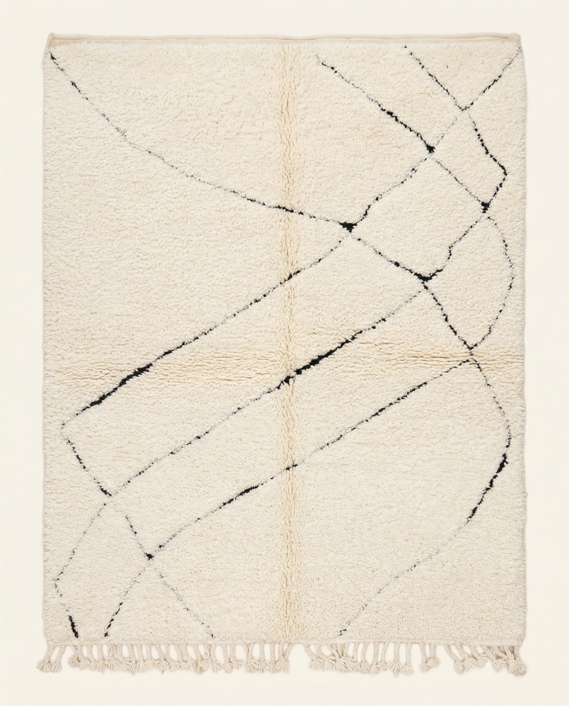 Plush ivory Beni Ourain Moroccan rug with a sparse black abstract diamond lattice and high pile, by NURA.