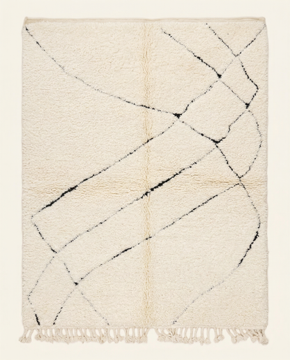Plush ivory Beni Ourain Moroccan rug with a sparse black abstract diamond lattice and high pile, by NURA.