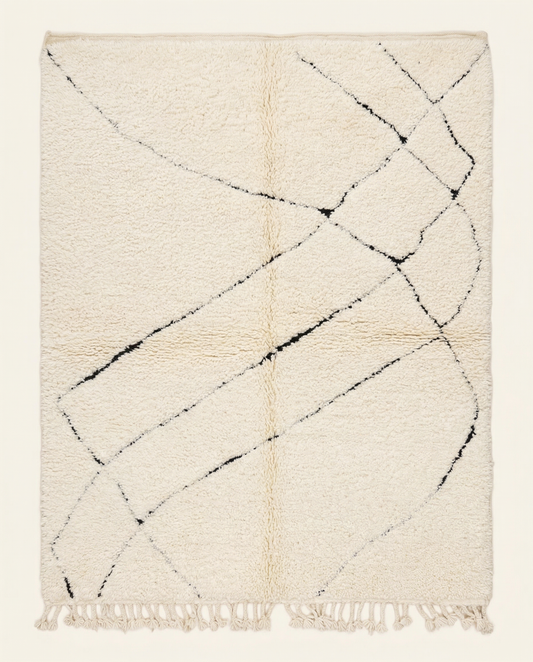 Plush ivory Beni Ourain Moroccan rug with a sparse black abstract diamond lattice and high pile, by NURA.