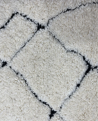 NASSIMA Beni Ourain ivory abstract diamond lattice Moroccan rug close-up showing hand-knotted wool texture and pile detail, by NURA