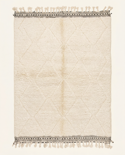 Plush cream Beni Ourain Moroccan rug with a sparse diamond lattice and flat-woven striped end bands, by NURA.