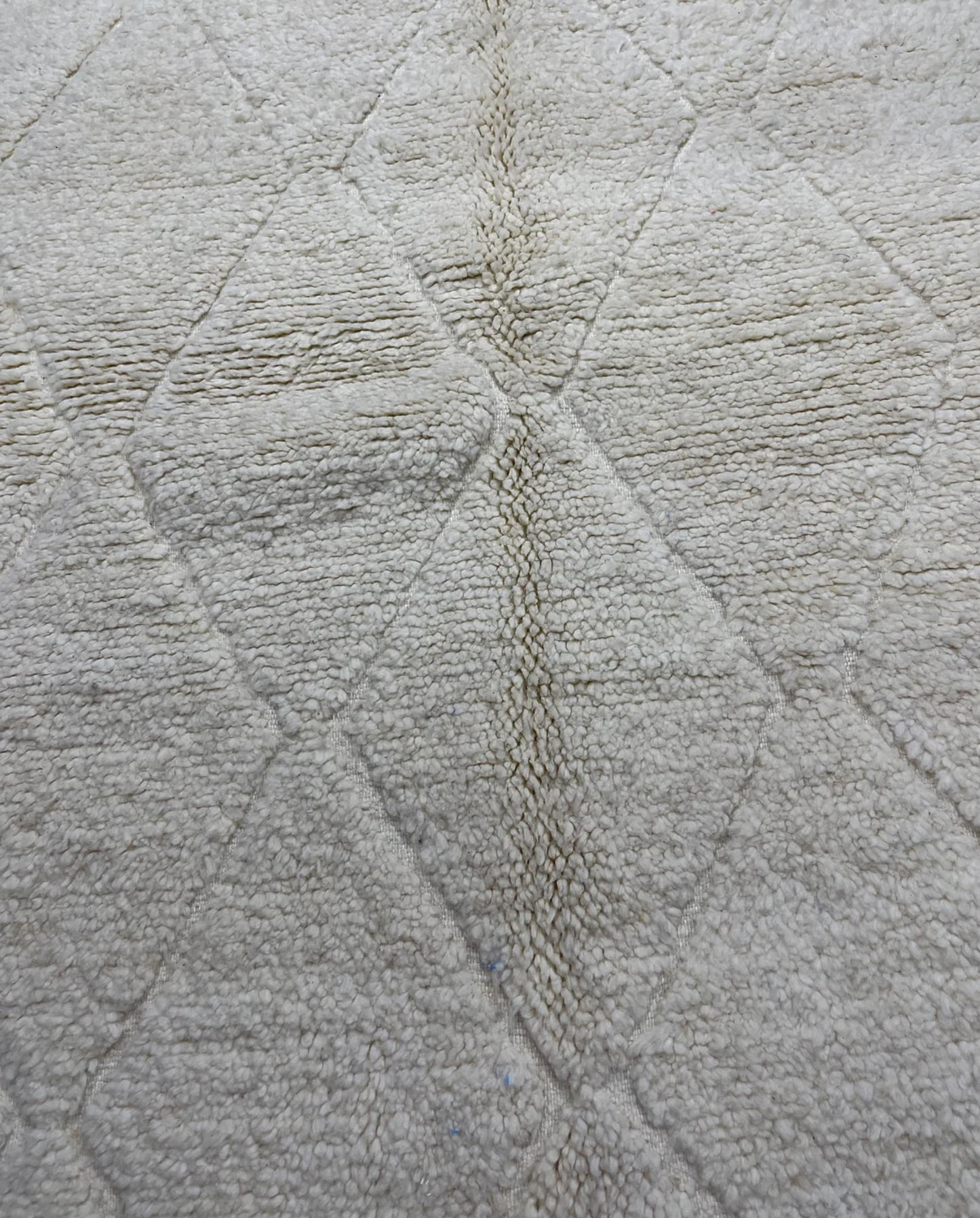 NASSIRA Beni Ourain cream diamond lattice Moroccan rug close-up showing hand-knotted wool texture and pile detail, by NURA