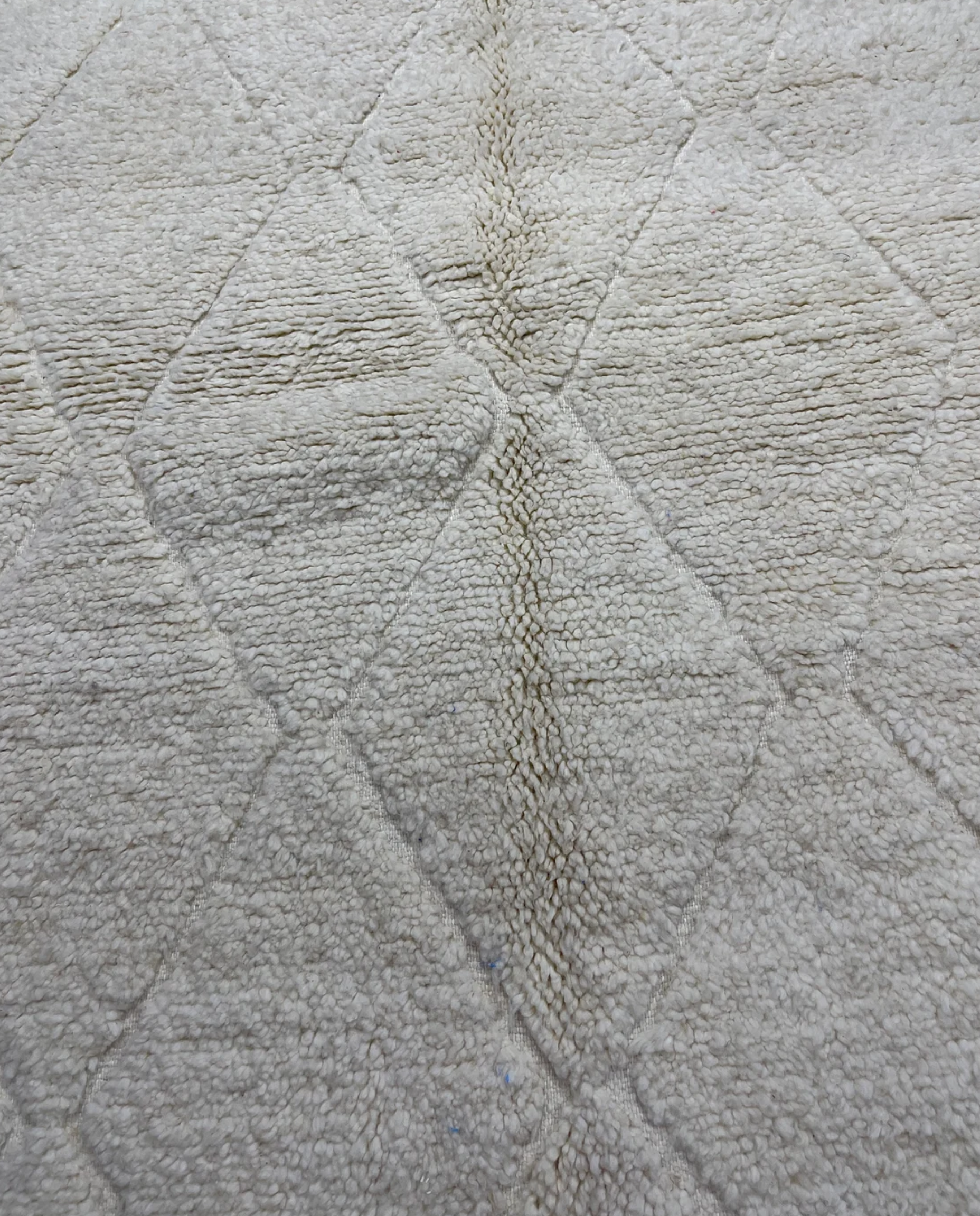 NASSIRA Beni Ourain cream diamond lattice Moroccan rug close-up showing hand-knotted wool texture and pile detail, by NURA