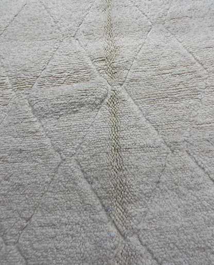 NASSIRA Beni Ourain cream diamond lattice Moroccan rug close-up showing hand-knotted wool texture and pile detail, by NURA
