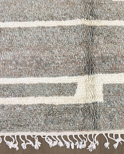NESRINE Beni Ourain taupe broken stripe Moroccan rug close-up of hand-tied fringe and kilim band detail, by NURA