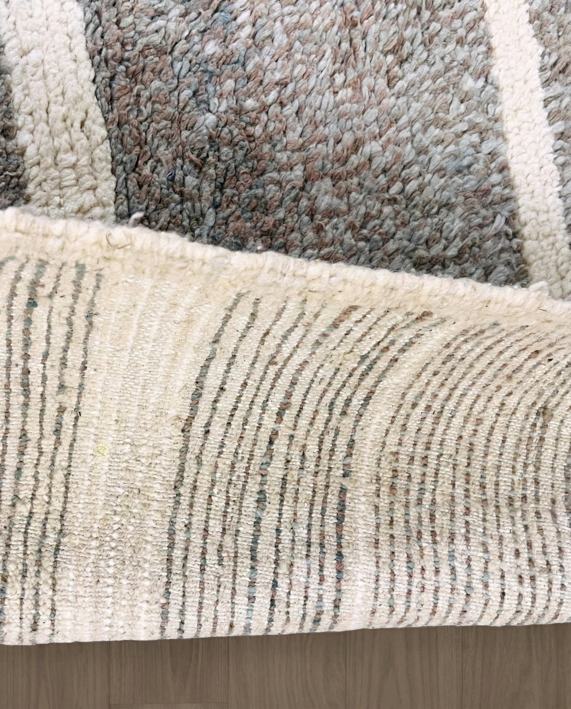 NESRINE Beni Ourain taupe broken stripe Moroccan rug close-up showing hand-knotted wool texture and pile detail 3, by NURA