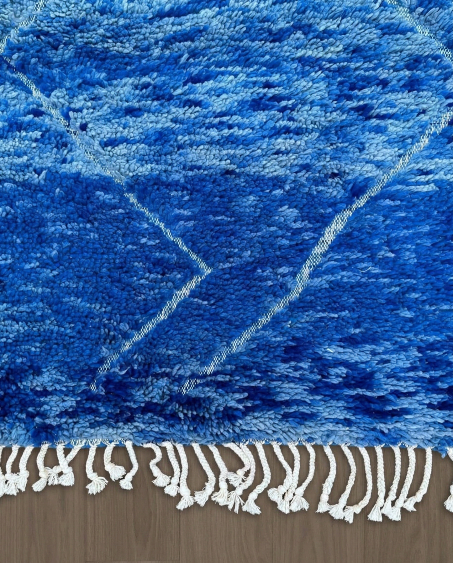 NOUHA Beni Ourain cobalt diamond lattice Moroccan rug close-up of hand-tied fringe and kilim band detail, by NURA