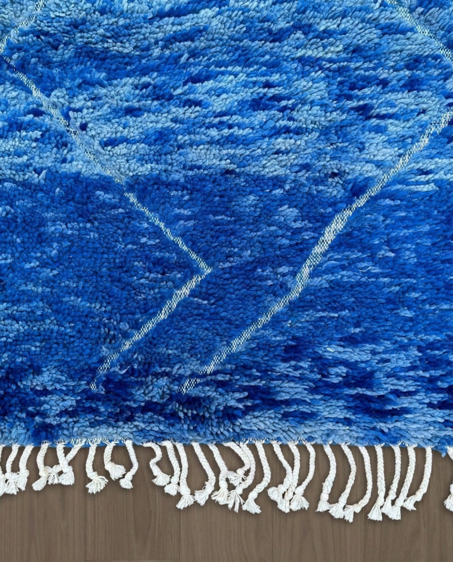 NOUHA Beni Ourain cobalt diamond lattice Moroccan rug close-up of hand-tied fringe and kilim band detail, by NURA