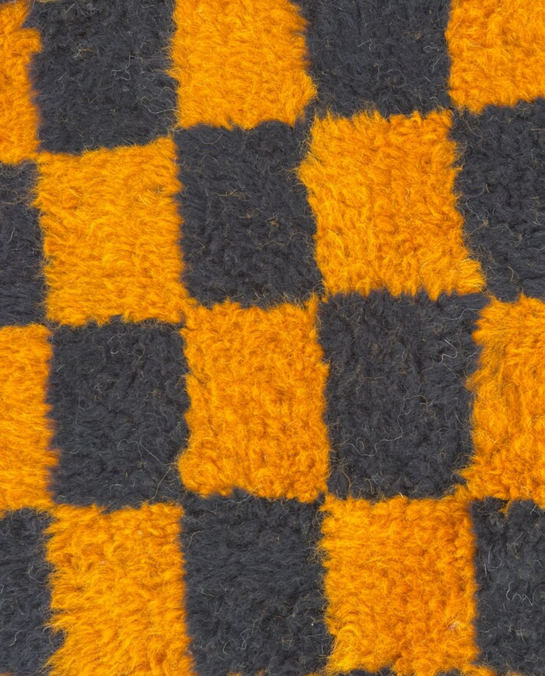 NOUHAILA Beni Ourain burnt orange bold checkerboard Moroccan rug close-up showing hand-knotted wool texture and pile detail, by NURA