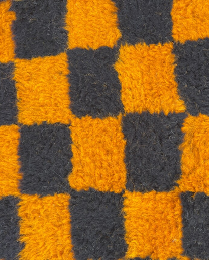 NOUHAILA Beni Ourain burnt orange bold checkerboard Moroccan rug close-up showing hand-knotted wool texture and pile detail, by NURA