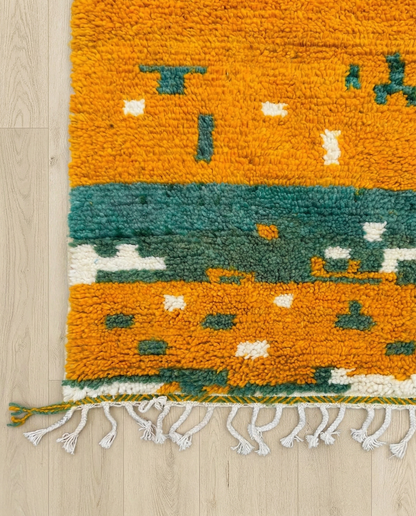 NOUR Beni Ourain saffron striped framed field Moroccan rug close-up of hand-tied fringe and kilim band detail, by NURA