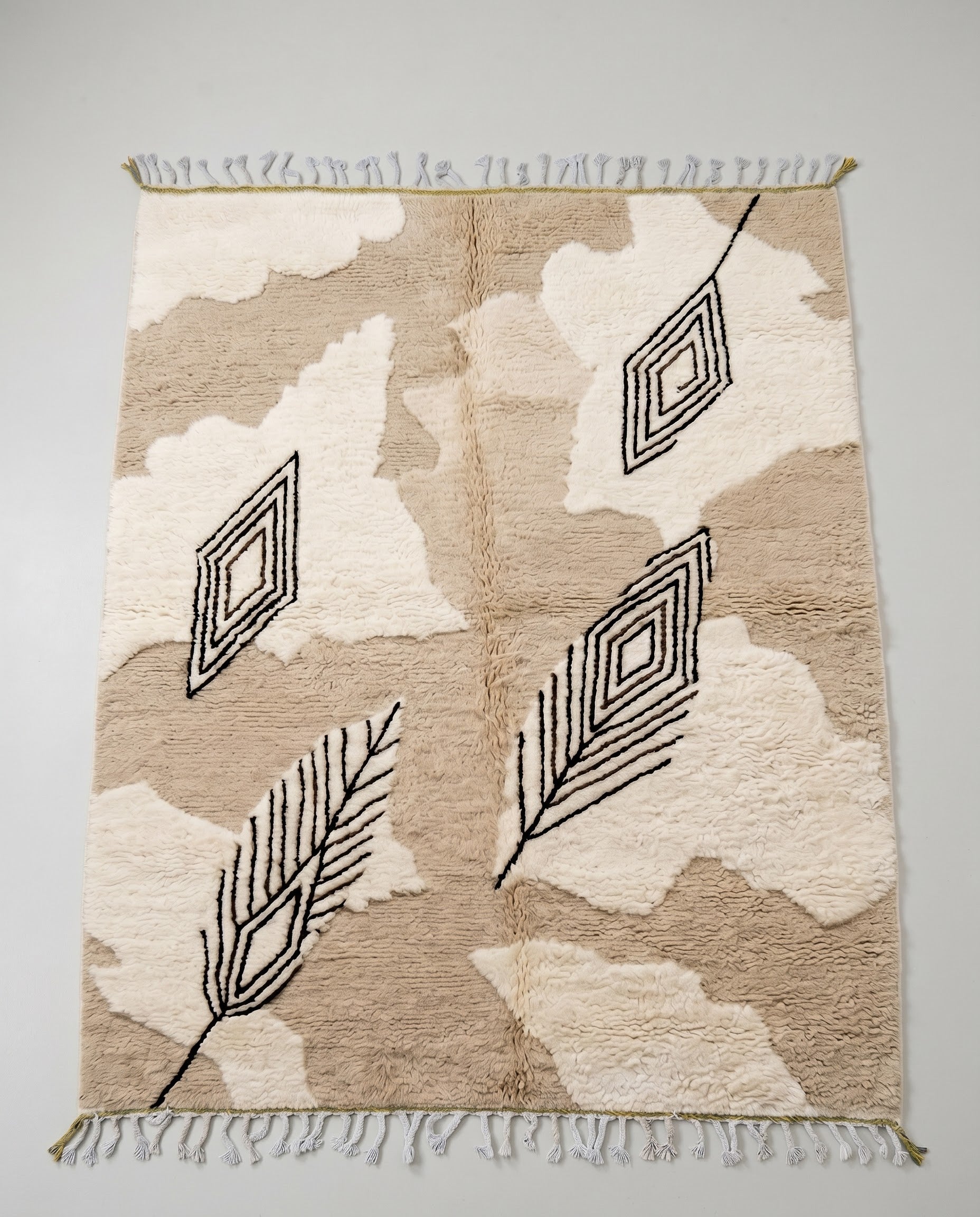 NOURIA Beni Ourain beige floating forms Moroccan rug displayed on a parquet wood floor, showing full fringe and edge detail, by NURA