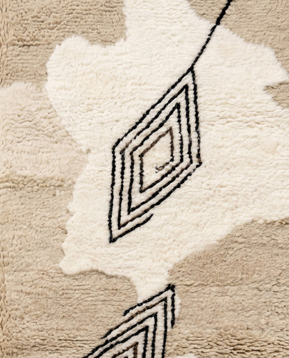 NOURIA Beni Ourain beige floating forms Moroccan rug close-up showing hand-knotted wool texture and pile detail, by NURA