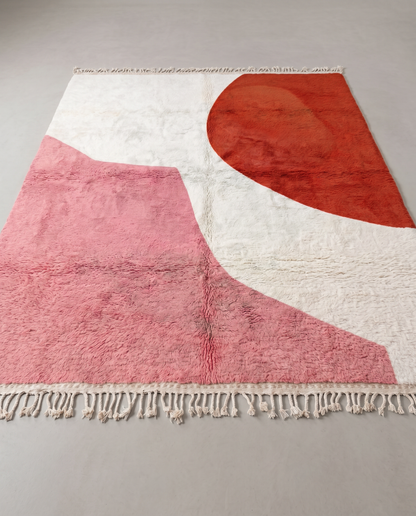 NOUZHA Beni Ourain cream color block Moroccan rug displayed on a parquet wood floor, showing full fringe and edge detail, by NURA