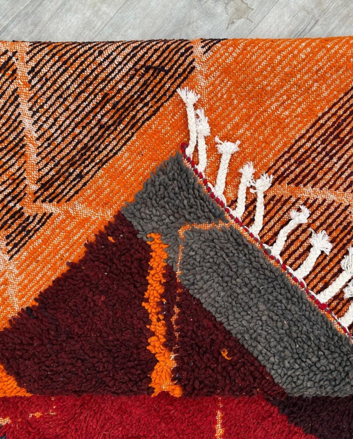OUMNIA Azilal red banded diamond lattice Moroccan rug back view showing traditional handwoven construction, by NURA