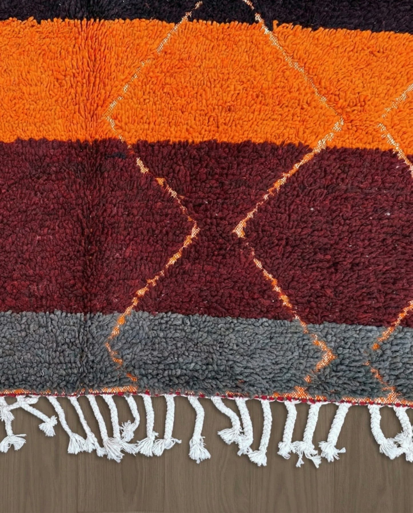 OUMNIA Azilal red banded diamond lattice Moroccan rug close-up of hand-tied fringe and kilim band detail, by NURA