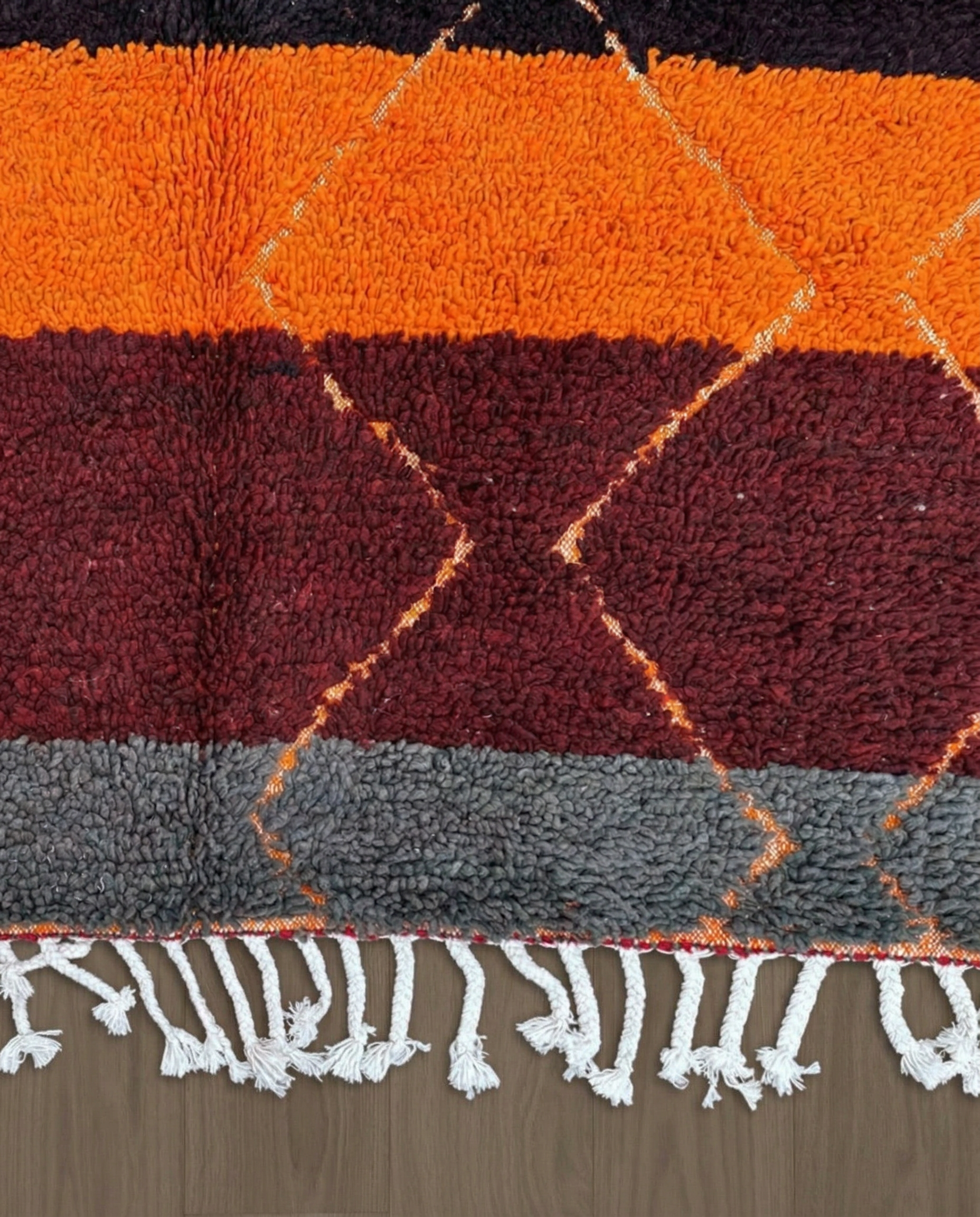 OUMNIA Azilal red banded diamond lattice Moroccan rug close-up of hand-tied fringe and kilim band detail, by NURA