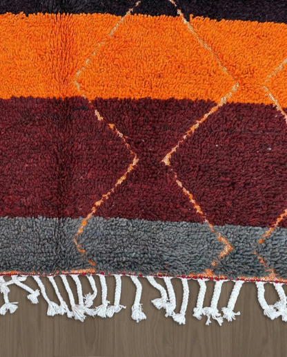 OUMNIA Azilal red banded diamond lattice Moroccan rug close-up of hand-tied fringe and kilim band detail, by NURA