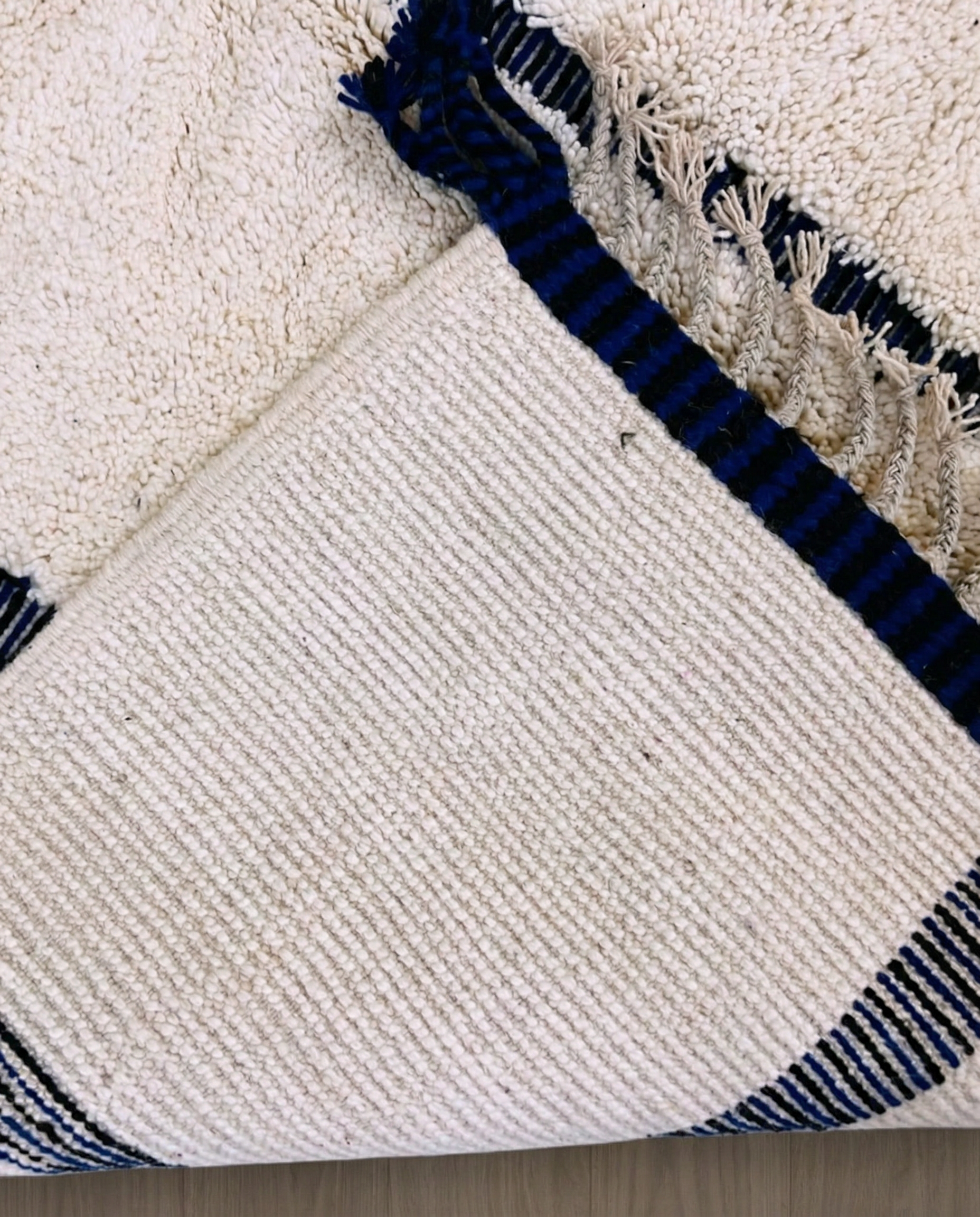 RABAB Beni Ourain cream abstract linear field Moroccan rug back view showing traditional handwoven construction, by NURA