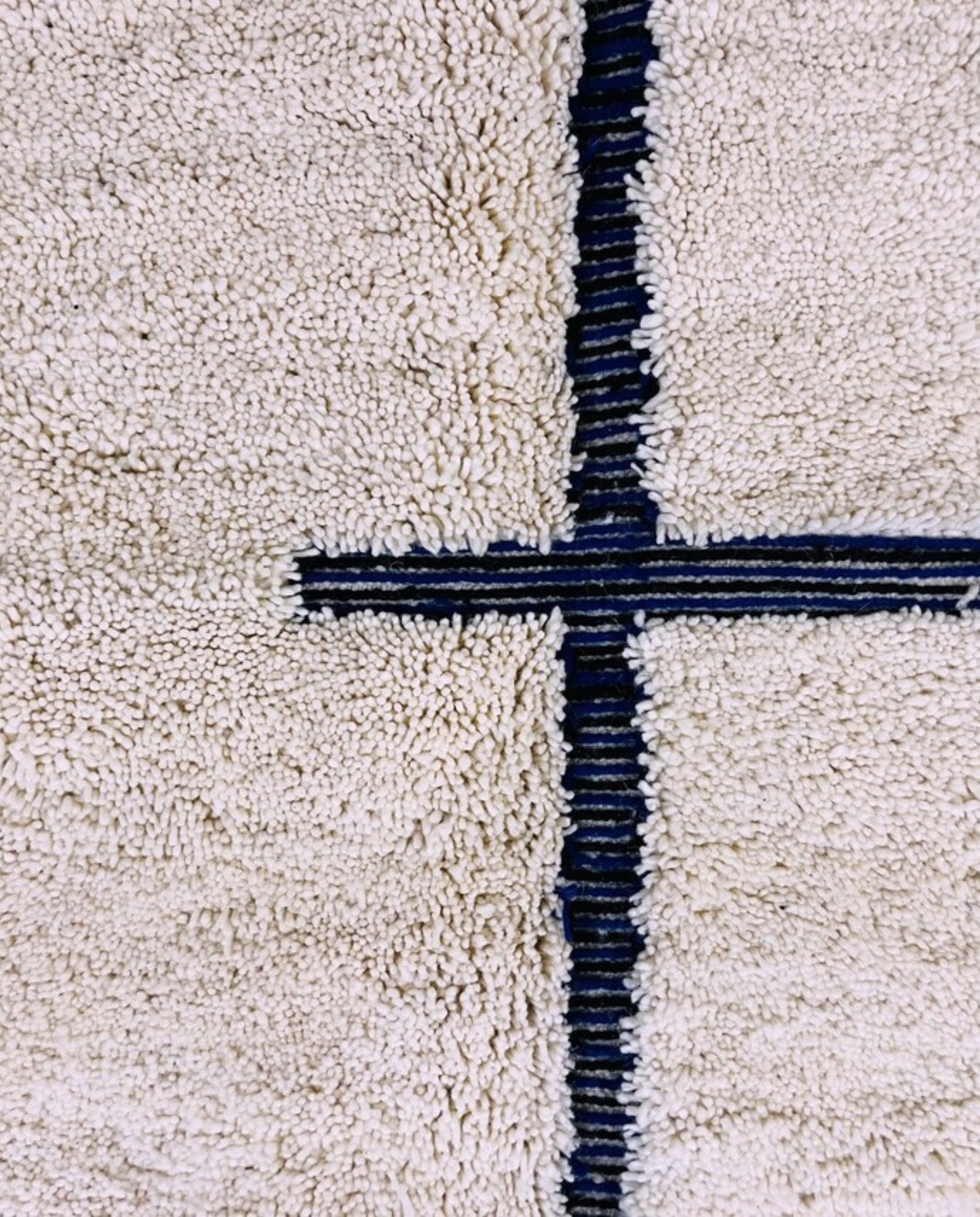 RABAB Beni Ourain cream abstract linear field Moroccan rug close-up showing hand-knotted wool texture and pile detail 1, by NURA