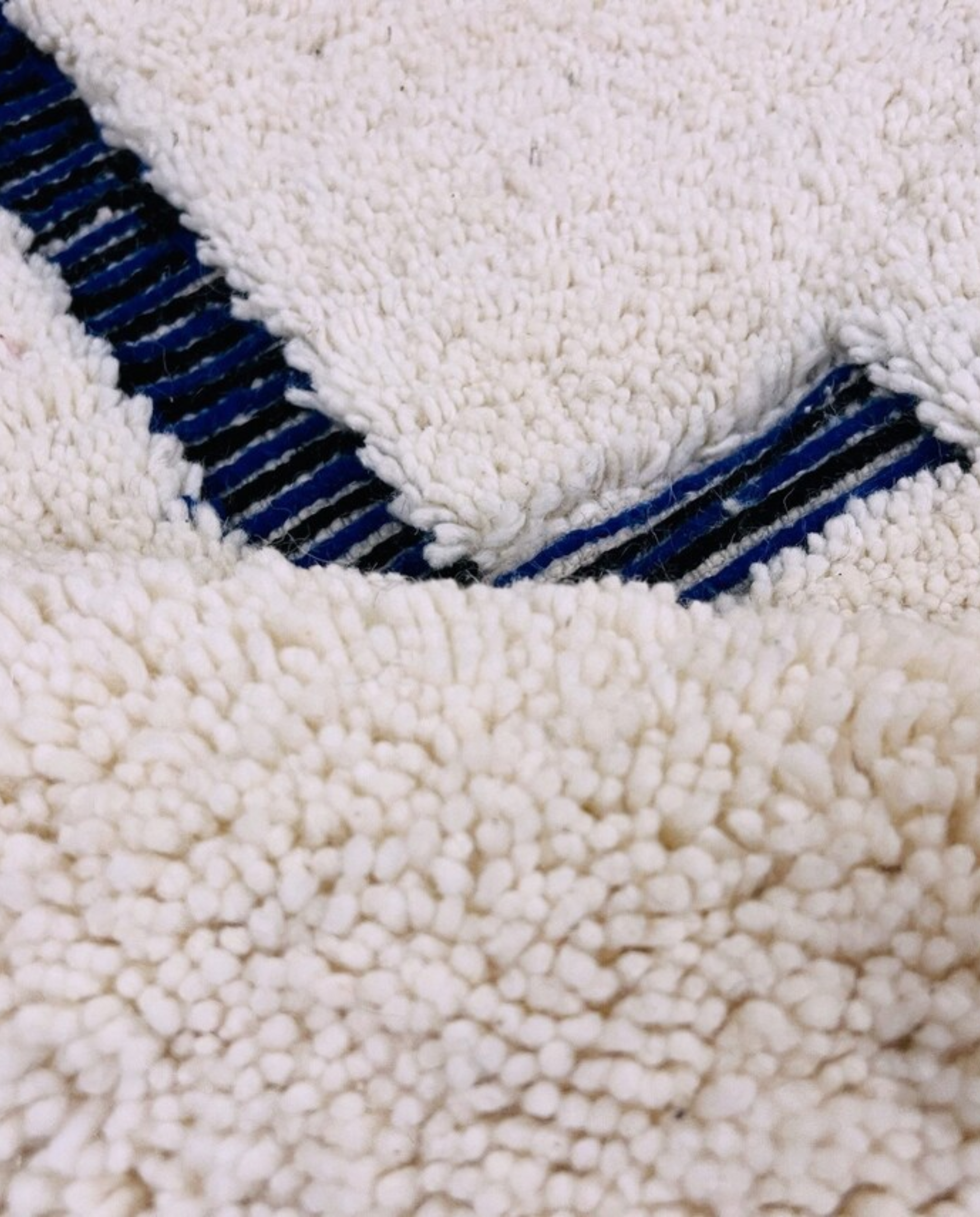 RABAB Beni Ourain cream abstract linear field Moroccan rug close-up showing hand-knotted wool texture and pile detail 2, by NURA