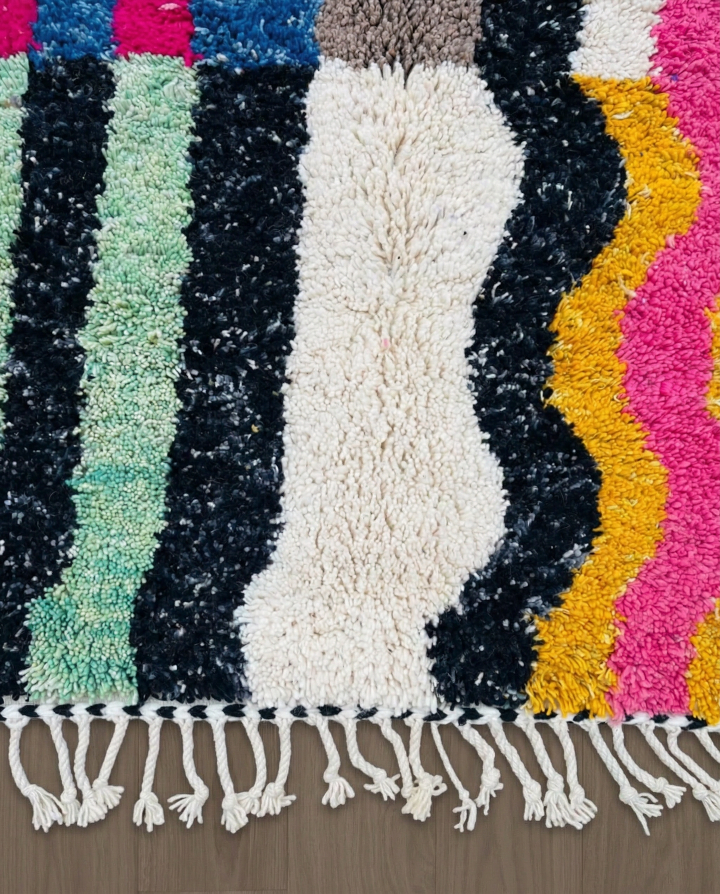 RABIA Beni Ourain ivory abstract striped field Moroccan rug close-up of hand-tied fringe and kilim band detail, by NURA