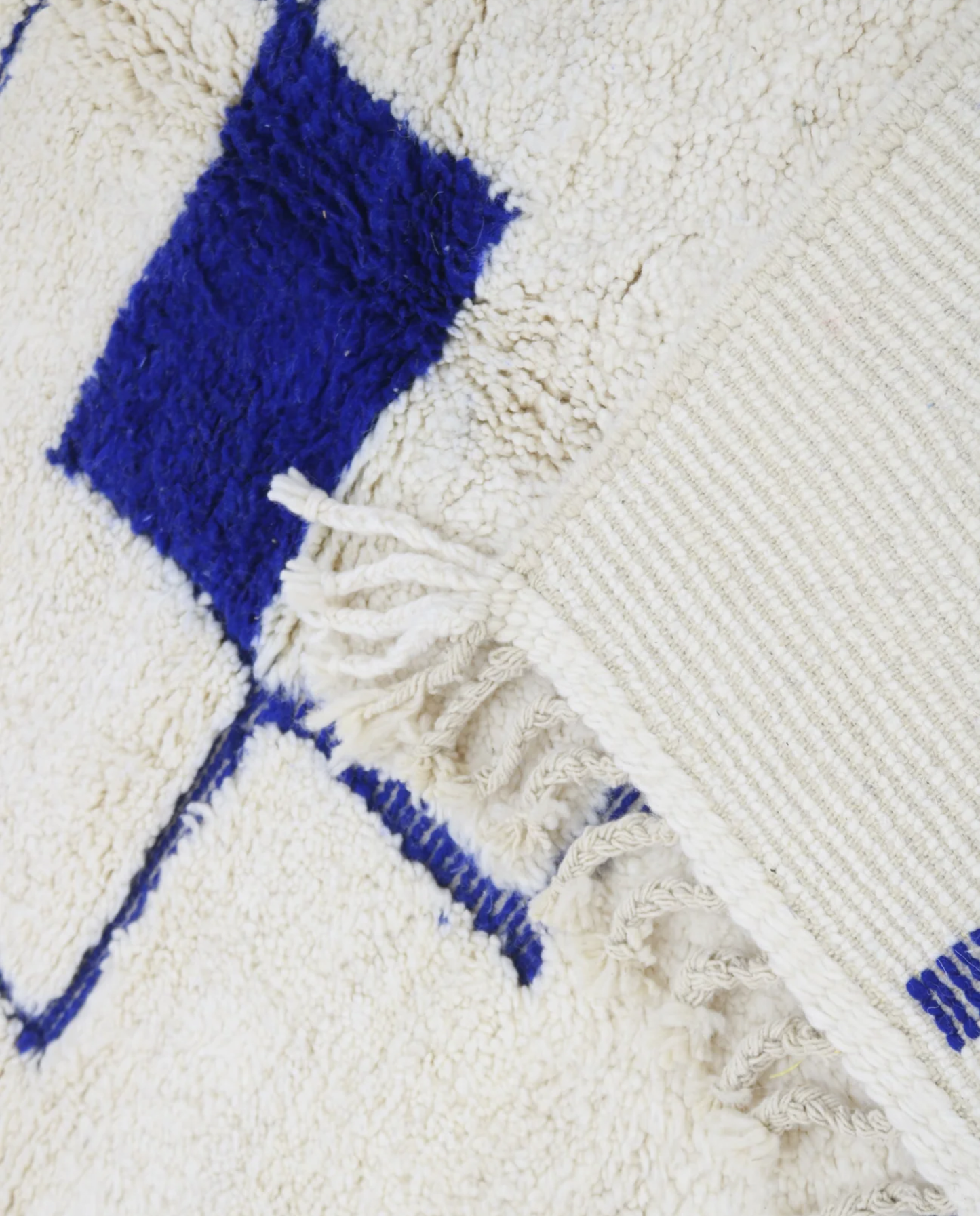 RADNA Azilal cream floating forms Moroccan rug close-up of hand-tied fringe and kilim band detail, by NURA