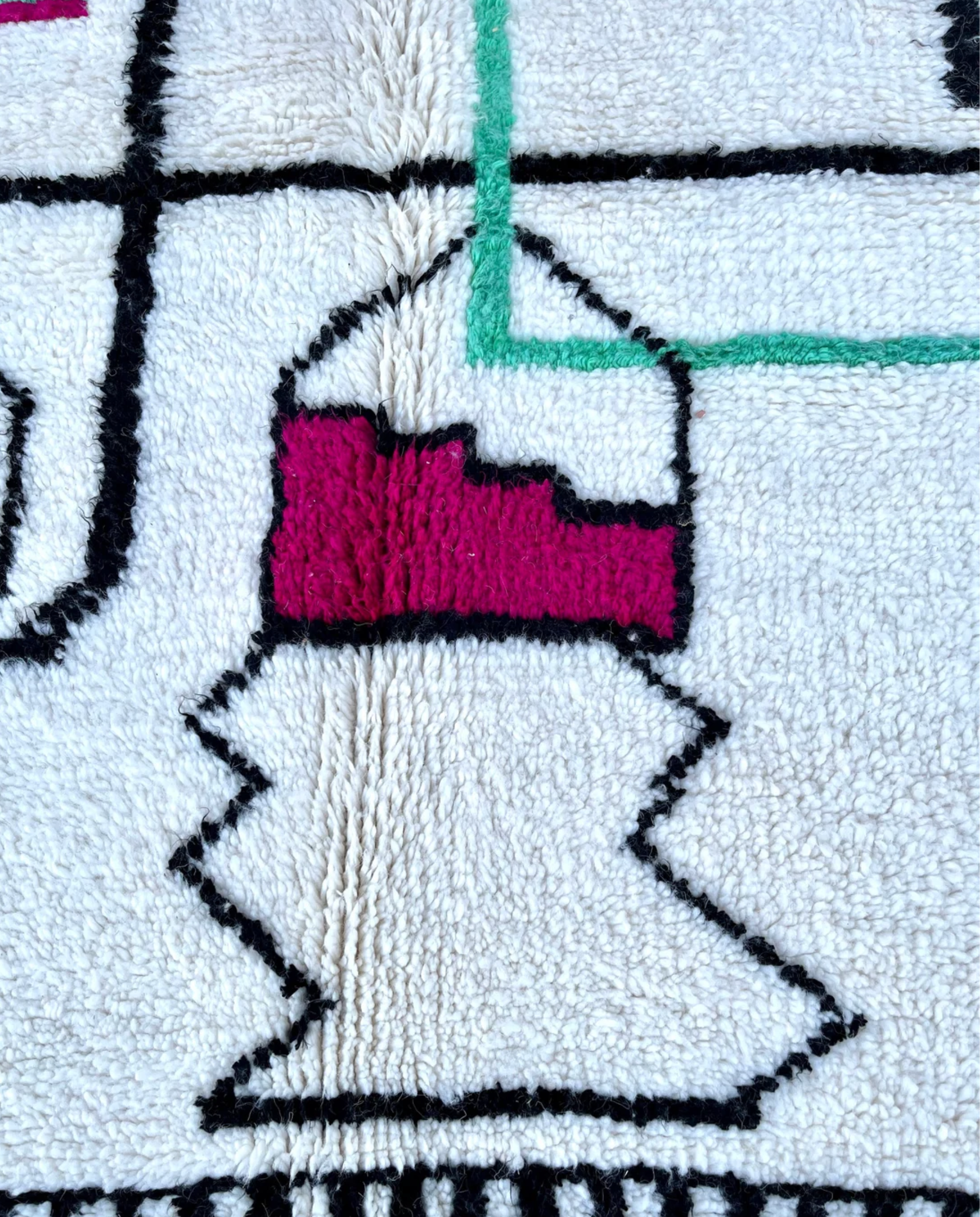 RADWA Azilal ivory scattered abstract motifs Moroccan rug close-up showing hand-knotted wool texture and pile detail 1, by NURA